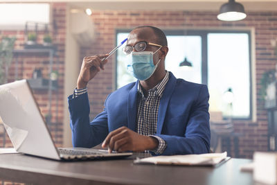 Businessman wearing mask working at office