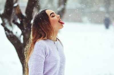 Portrait of young woman in snow