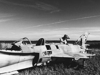 Airplane on field against sky