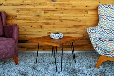 High angle view of table and chairs on floor at home