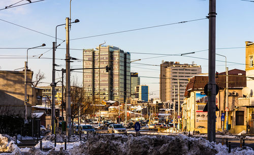 Street amidst buildings against sky during winter