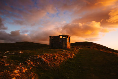 Old building against sky during sunset