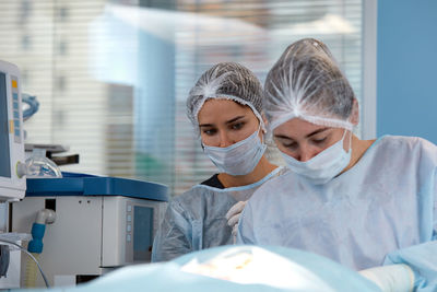 Midsection of scientist working in laboratory