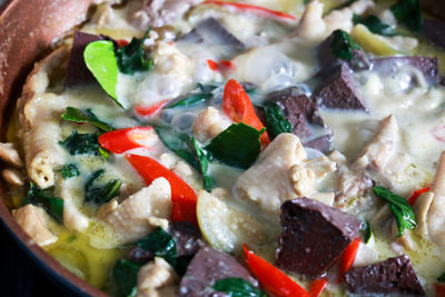 Green curry with chicken in thai pot concept.