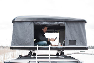 Man working from a tent whilst social distancing from the office