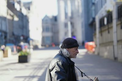 Side view of mature man standing in city