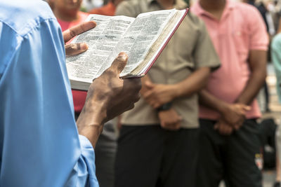 Man evangelical preacher explains god's word in se square in downtown sao paulo