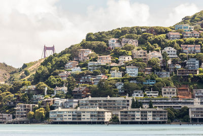 View of townscape by sea against sky