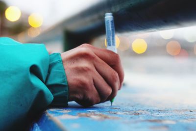 Close-up of man holding hands on table