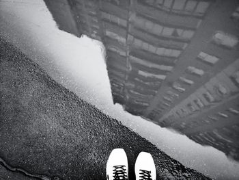 Low section of person standing on tiled floor