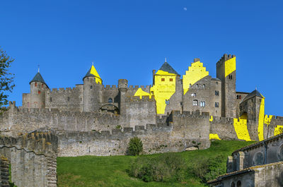 Low angle view of historic building against blue sky