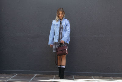 Woman standing against wall