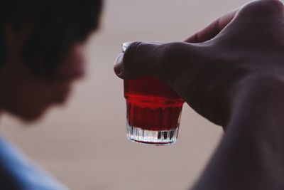 Close-up of man holding glass