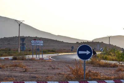 Road sign against clear sky