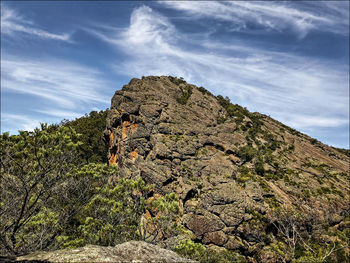 Low angle view of rock formation against sky