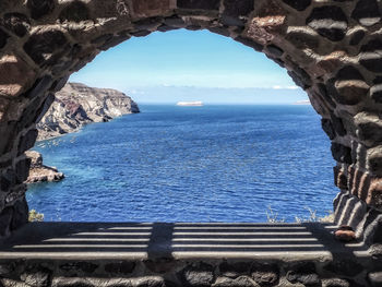 Scenic view of sea through stone arch