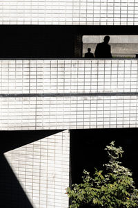 Silhouette man against building wall