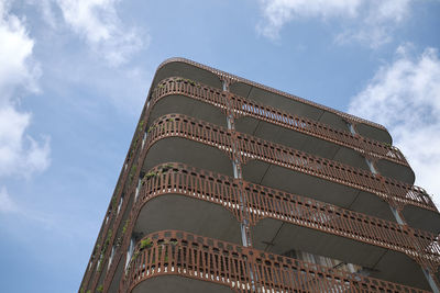 Low angle view of building against cloudy sky