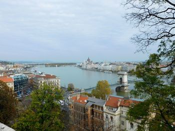 View of buildings in town against cloudy sky