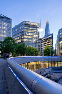 Modern buildings in city against blue sky