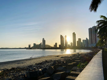 City buildings against sky during sunset