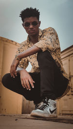 Portrait of young man sitting outdoors