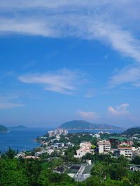 High angle view of townscape by sea against sky