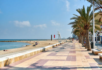 Promenade by sea against sky