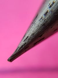 Close-up of colored pencils against pink background