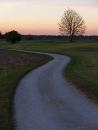 Scenic view of field against sky at sunset