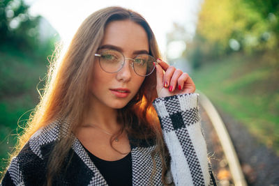 Sunny portrait young woman in glasses