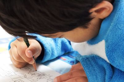 Close-up of boy drawing on paper