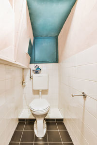 Low section of woman standing in bathroom