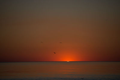 Scenic view of sea against sky at sunset