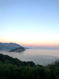 Scenic view of sea against clear sky during sunset