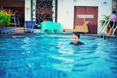 Boy swimming in pool