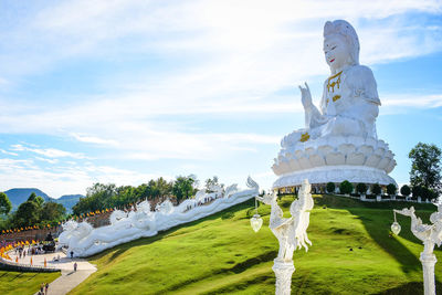 Statue against sky and building