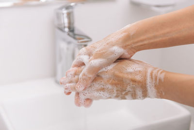 Man washing hands in bathroom