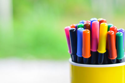 Close-up of multi colored pencils on table