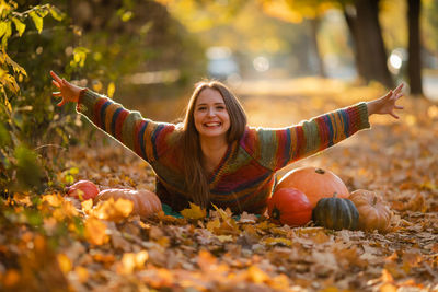 Portrait of young woman sitting on field