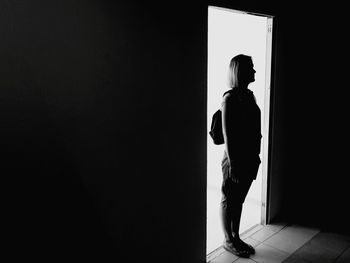 Side view of silhouette man standing at home