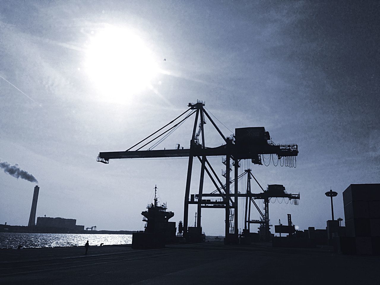 sun, sunbeam, sky, built structure, sunlight, low angle view, architecture, silhouette, lens flare, building exterior, crane - construction machinery, cloud - sky, sunset, fuel and power generation, construction site, bright, outdoors, industry, no people, cloud