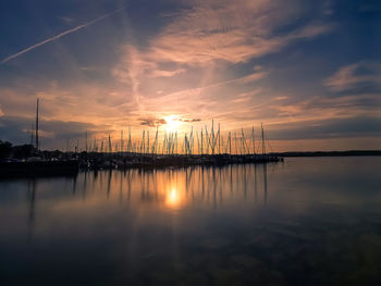 Sailboats in marina at sunset