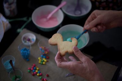 High angle view of person holding cookies on table