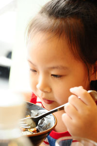 Close-up portrait of cute girl holding ice cream