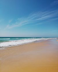 Scenic view of beach against clear blue sky