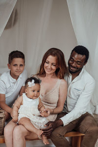 Happy friends sitting on the floor