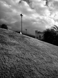 Empty road against cloudy sky