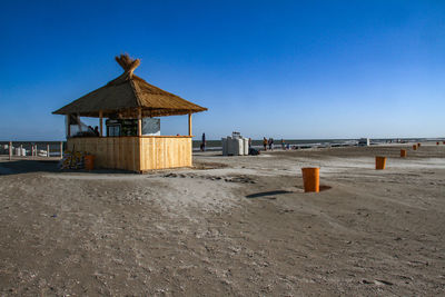 Lifeguard hut on beach against clear sky