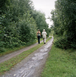 Women walking through dirt road